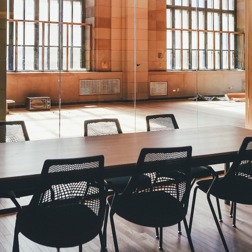 rectangular brown wooden dining table and black steel chairs